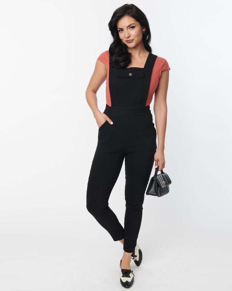 Front of a model wearing a size 2X Unique Vintage Black Skinny Leg Overalls in Black by Unique Vintage. | dia_product_style_image_id:315404